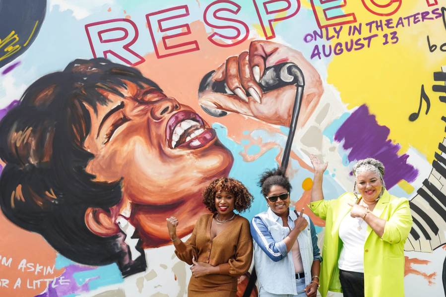Jennifer Hudson, from left, poses with muralist Desiree Kelly and film director Liesl Tommy in front of an Aretha Franklin mural Aug. 1 outside of the Charles H. Wright Museum of African American History in Detroit.