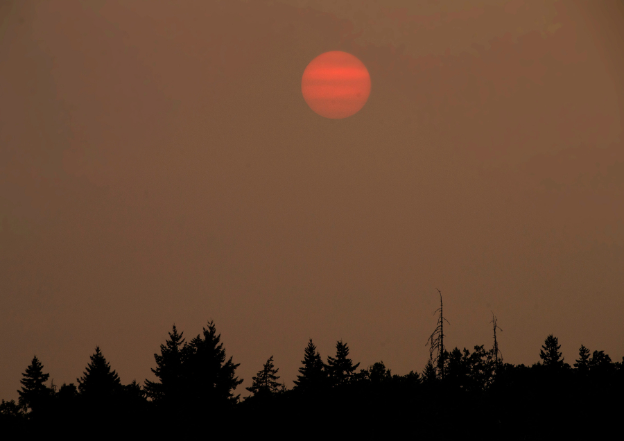 The sun sets Tuesday over Eugene, Ore., behind a blanket of thick smoke from wildfires burning in Oregon.