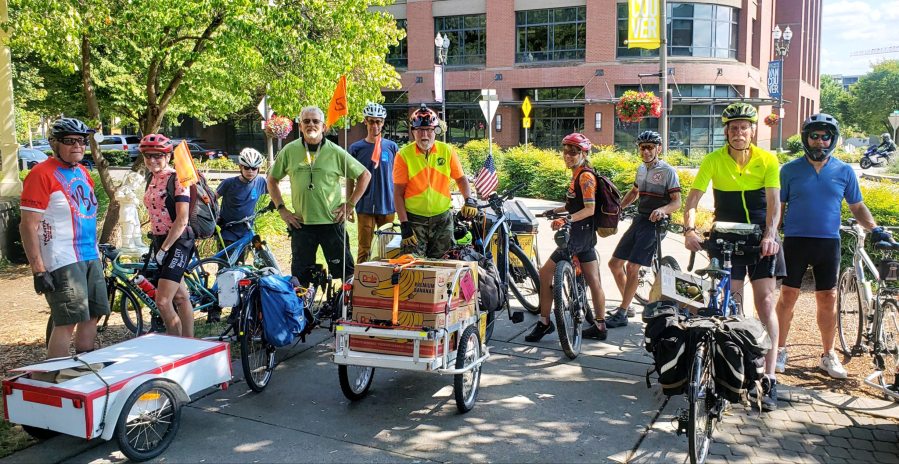 Members of the Vancouver Bike Club prepare to depart from the Vancouver Farmers Market withy a load of donated food bound for the Clark County food Bank. On most Sundays, club members gather at the downtown Vancouver event to pick up donations, which benefit the food bank and its partner agencies.