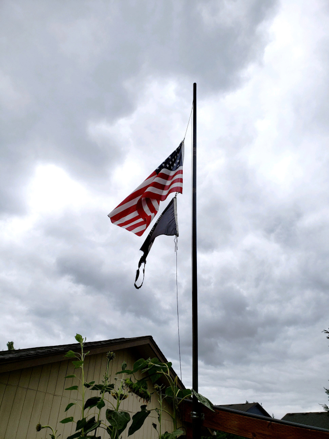 The U.S. flag is displayed at half staff on a home's flagpole recently following the Aug. 24 death of longtime Scouting volunteer Greg Hamilton at the age of 65.