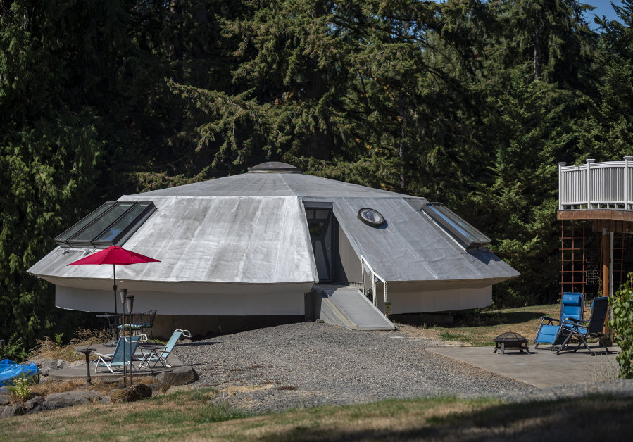 A retro-futuristic, UFO-themed Airbnb sits next to the home of Kirby and Patricia Swatosh on Monday in Brush Prairie.