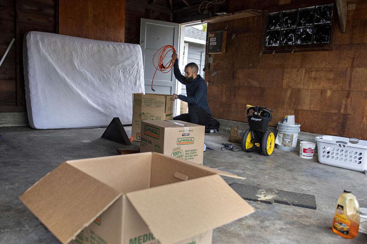 Raoul Campbell-Rouzan of Vancouver packs up his garage while gearing up for his upcoming move to Arizona on Friday morning. A record number of people are quitting their jobs during the pandemic.