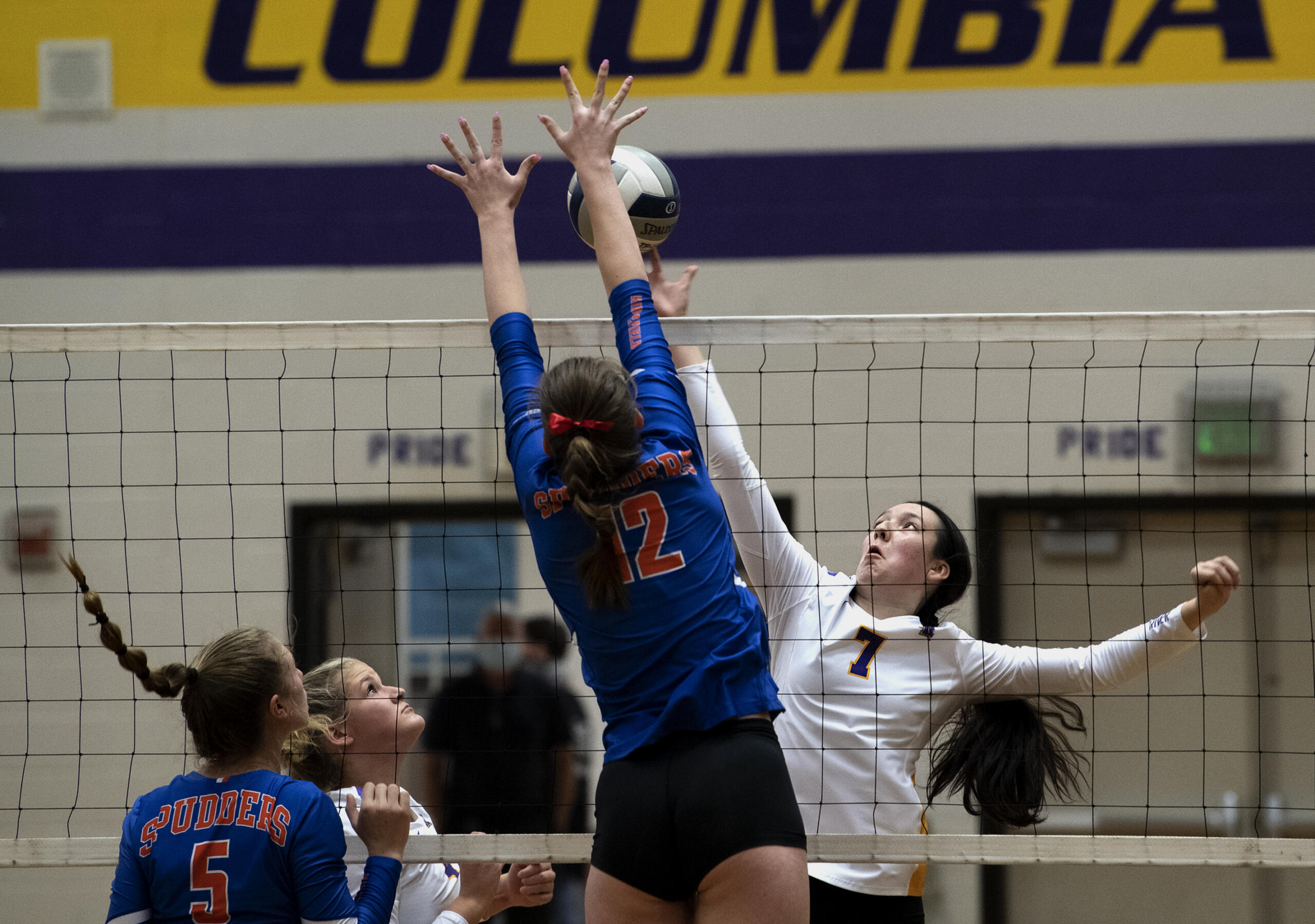 Ridgefield’s Emily Vossenkuhl, front, tries to block a tip from Columbia River’s Aaliyah Turner during a volleyball match Sept. 21 at Columbia River High School. Thursday, Columbia River avenged that earlier loss with a 3-1 win over Ridgefield to snap the Spudders' 51-match win streak.
