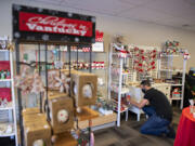 Manager Brandon Culp displays products on shelves while working at Christmas in Vantucky in Hazel Dell.