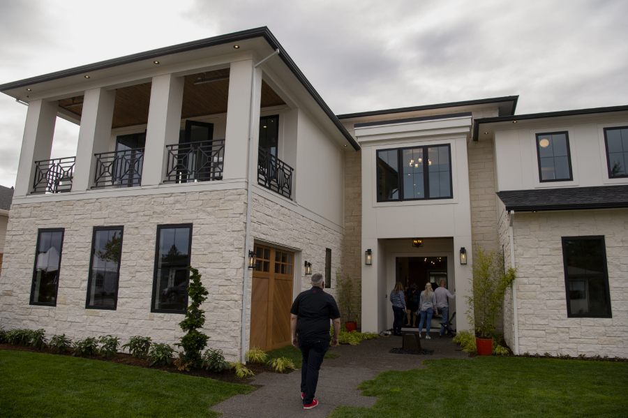 Guests file into a home at the Northwest Natural Parade of Homes on Wednesday in Felida. Some of the featured homes this year include Hardie Textured Panels, a new type of exterior siding that mimics the texture of stucco rather than wood.