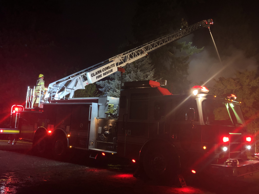 Firefighters battle a Sunday night fire that destroyed a Ridgefield house. The fire was caused by a portable heater in a bedroom, according to the Clark County Fire Marshal's Office.
