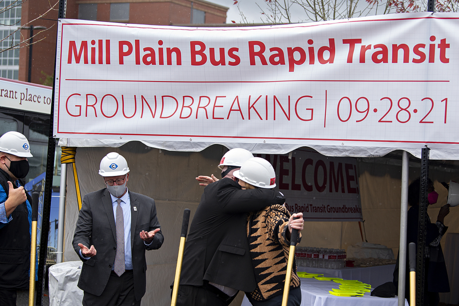 C-Tran CEO Shawn Donaghy, left center with shovel, embraces Vancouver Mayor Anne McEnerny-Ogle at the Clark College Columbia Tech Center campus as they celebrate the groundbreaking for the new Mill Plain Bus Rapid Transit line Tuesday afternoon.