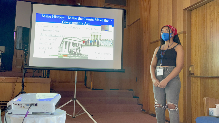 Gracie Taylor makes a presentation to an audience including Port of Vancouver Commissioner Eric LaBrant during a recent Youth Acting for our Earth training.