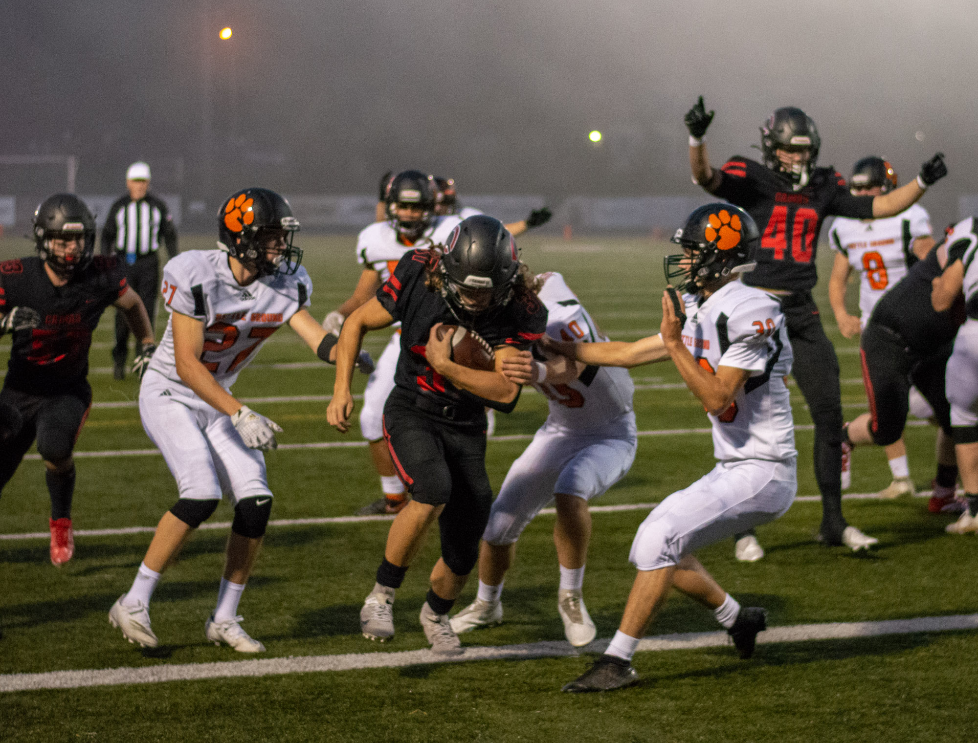 Jon Schultz, center, beats three Battle Ground defenders into the end zone for a game-opening score in a 4A Greater St. Helens League football game on Thursday, Sept. 30, 2021, at Doc Harris Stadium in Camas. Camas beat Battle Ground 56-6.