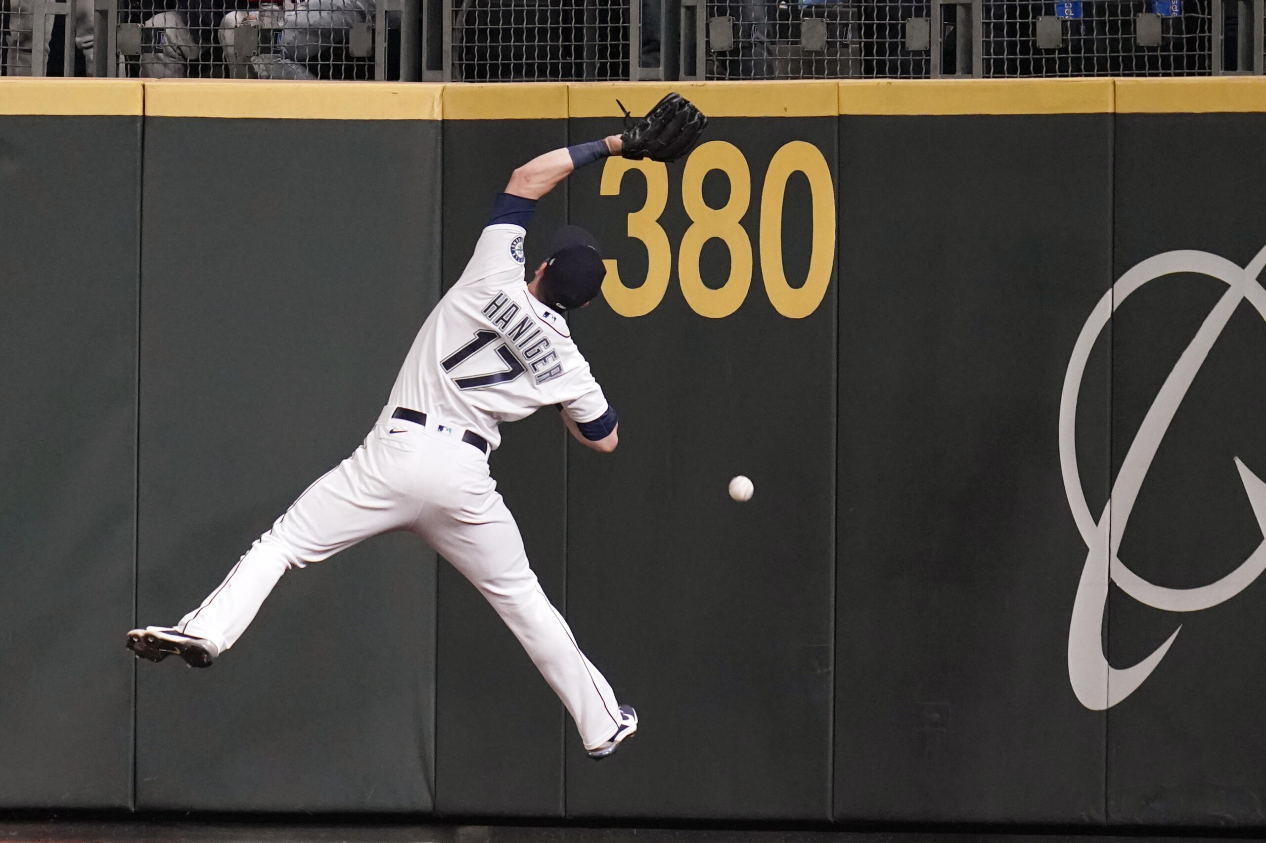 Seattle Mariners right fielder Mitch Haniger can't catch a deep fly ball that fell in for a triple by Boston Red Sox's Xander Bogaerts during the eighth inning of a baseball game Tuesday, Sept. 14, 2021, in Seattle.