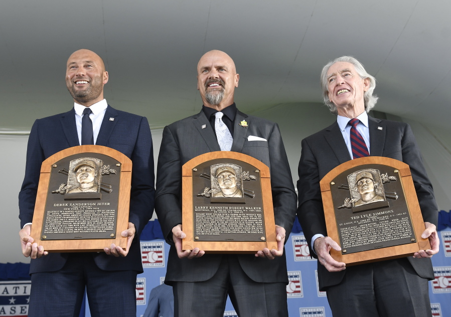 Hall of Fame inductees, from left, Derek Jeter, Larry Walker and Ted Simmons hold their plaques for photos after the induction ceremony at Clark Sports Center on Wednesday, Sept. 8, 2021, at the National Baseball Hall of Fame in Cooperstown, N.Y.