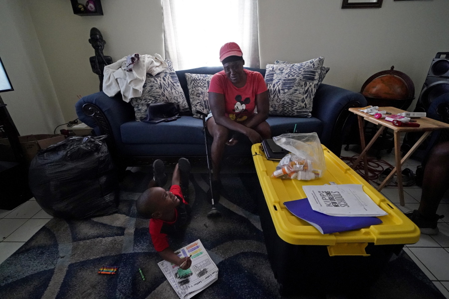 Natasha Blunt sits in her apartment with her grandson Kamille Blunt, 5, in the aftermath of Hurricane Ida in Chalmette, La., Monday, Sept. 6, 2021. Before the hurricane hit, the New Orleans native had hardly recovered from facing eviction and loss of her catering job during the pandemic. The storm, which left her in the dark and without power for several days, has taken Blunt to the brink. Unable to work as her health deteriorates from a pair of strokes, Blunt is still facing eviction while she cares for Kamille.