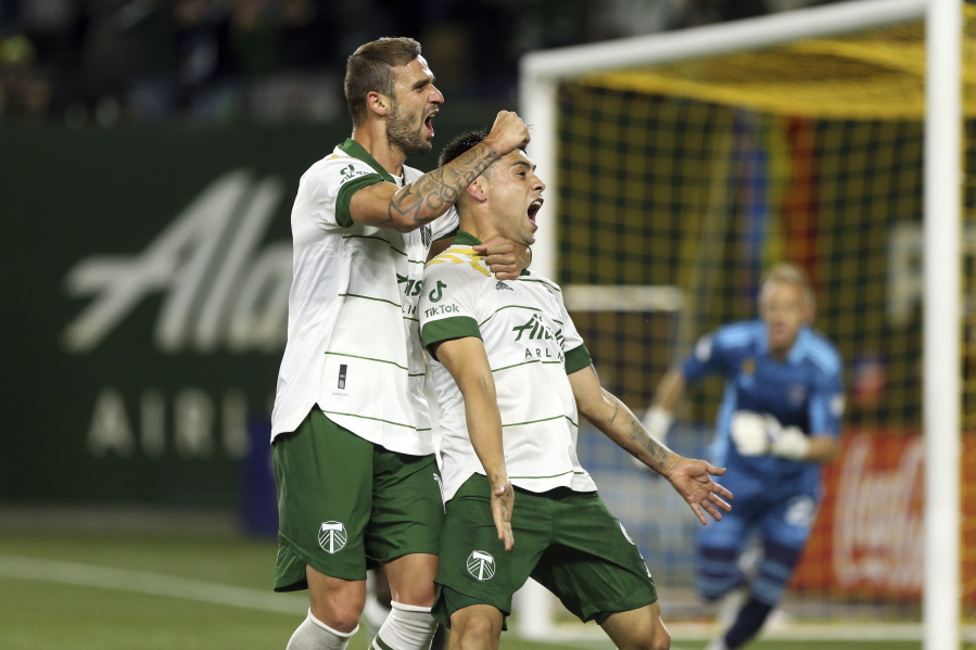 Portland Timbers forward Felipe Mora, front right, celebrates his second-half goal against the Colorado Rapids during an MLS soccer match Wednesday, Sept. 15, 2021, in Portland, Ore.