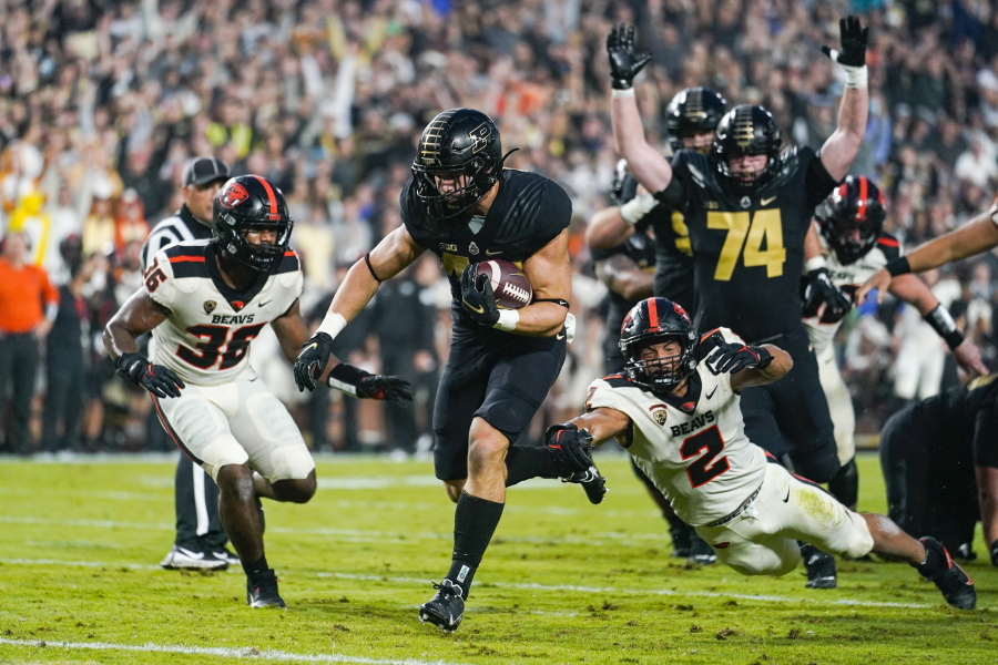 Purdue running back Zander Horvath (40) runs past Oregon State linebacker Andrzej Hughes-Murray (2) for a touchdown during the first half of an NCAA college football game in West Lafayette, Ind., Saturday, Sept. 4, 2021.