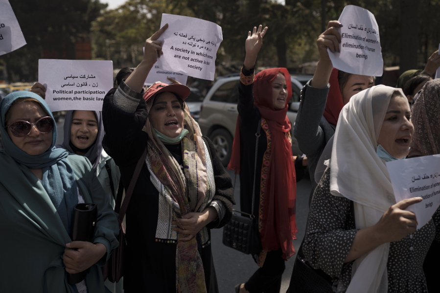 Women march to demand their rights under the Taliban rule during a demonstration near the former Women's Affairs Ministry building in Kabul, Afghanistan, Sunday, Sept. 19, 2021. The interim mayor of Afghanistan's capital said Sunday that many female city employees have been ordered to stay home by the country's new Taliban rulers.