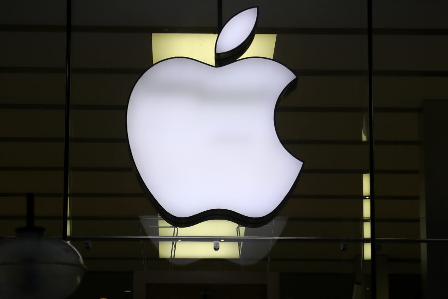 FILE - In this Wednesday, Dec. 16, 2020 file photo, the logo of Apple is illuminated at a store in the city center in Munich, Germany. Apple said Friday, Sept. 3, 2021 it's delaying its plan to scan U.S. iPhones for images of child sexual abuse, saying it needs more time to refine the system before releasing it. The company had revealed last month that it was working on a tool to detect known images of child sexual abuse, which would work by scanning files before they're uploaded to iCloud.