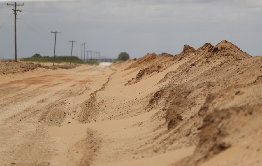 Sand that blew off farmers' fields is piled up in a ditch outside Lingo, N.M., near the Texas-New Mexico border on Tuesday, May 18, 2021. The U.S. Department of Agriculture is encouraging farmers in a "Dust Bowl zone" that includes parts of Texas, New Mexico, Oklahoma, Kansas and Colorado to establish and preserve grasslands to prevent wind erosion as the area becomes increasingly dry.