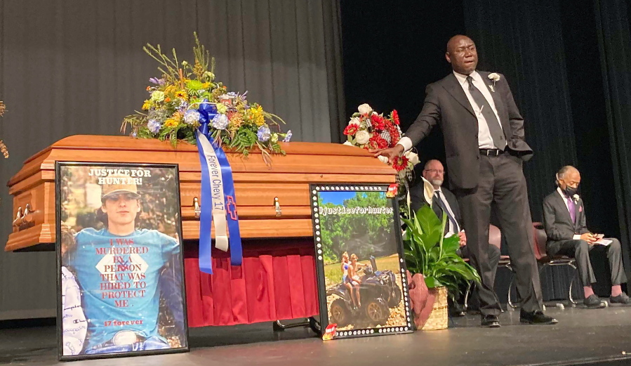 FILE - Attorney Ben Crump stands next to Hunter Brittain's casket at the Beebe High School Auditorium before his memorial service in Beebe, Ark., on Tuesday, July 6, 2021. Brittain was shot and killed by a Lonoke County Sheriff's deputy during a traffic stop June 23.