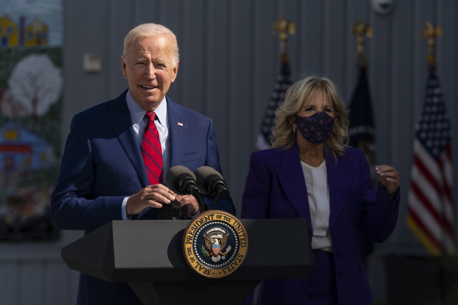 President Joe Biden, with first lady Jill Biden, speaks during a visit at Brookland Middle School in northeast Washington, Friday, Sept. 10, 2021. Biden has encouraged every school district to promote vaccines, including with on-site clinics, to protect students as they return to school amid a resurgence of the coronavirus.