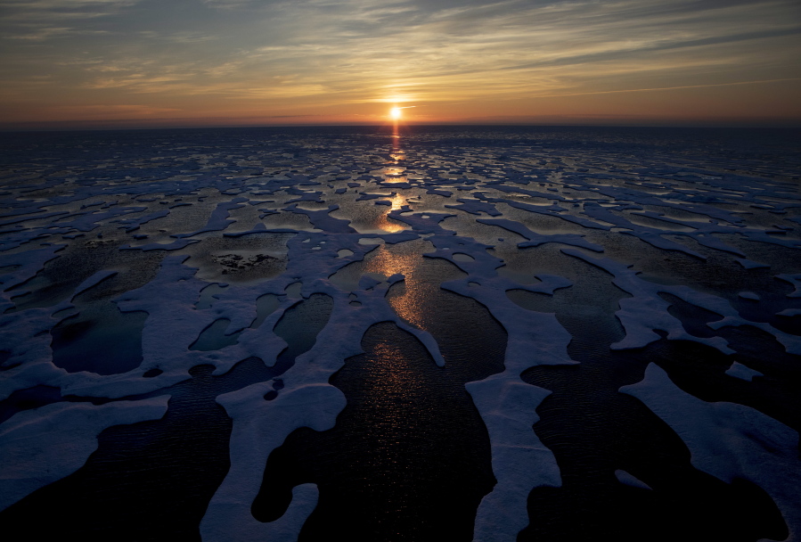 FILE - In this July 22, 2017, file photo the midnight sun shines across sea ice along the Northwest Passage in the Canadian Arctic Archipelago. The Biden administration is stepping up its work to figure about what to do about the thawing Arctic, which is warming three times faster than the rest of the world. The White House said Friday, Sept. 24, 2021, that it is reactivating the Arctic Executive Steering Committee, which coordinates domestic regulations and works with other Arctic nations. It also is adding six new members to the U.S. Arctic Research Commission, including two indigenous Alaskans.