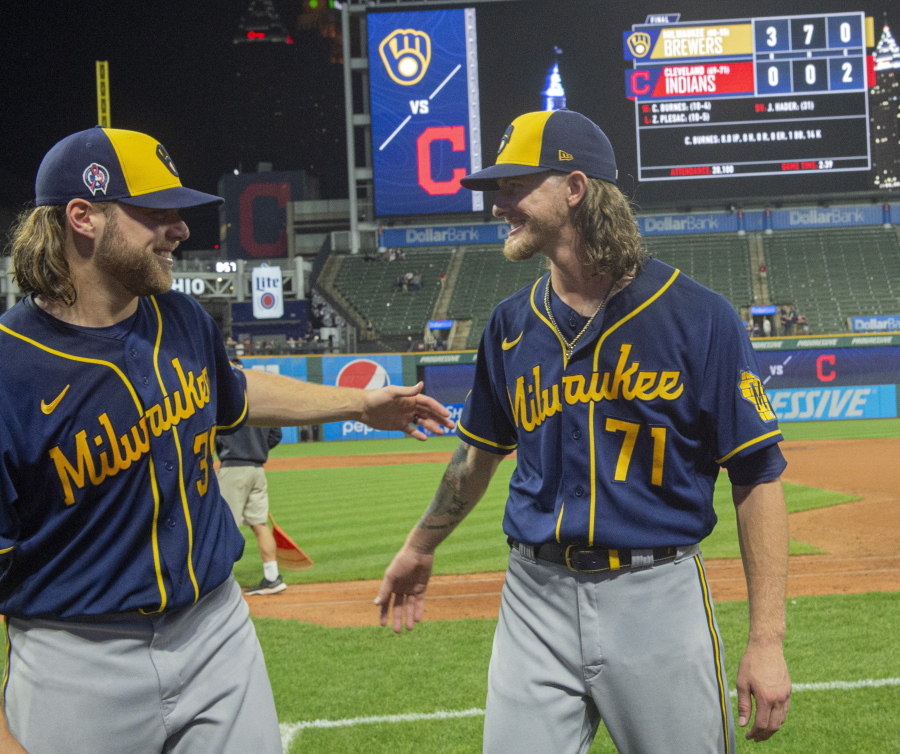 Milwaukee Brewers starter Corbin Burnes, left, and reliever Josh Hader celebrate after pitching a combined no-hitter against the Cleveland Indians in a baseball game in Cleveland, Saturday, Sept. 11, 2021.
