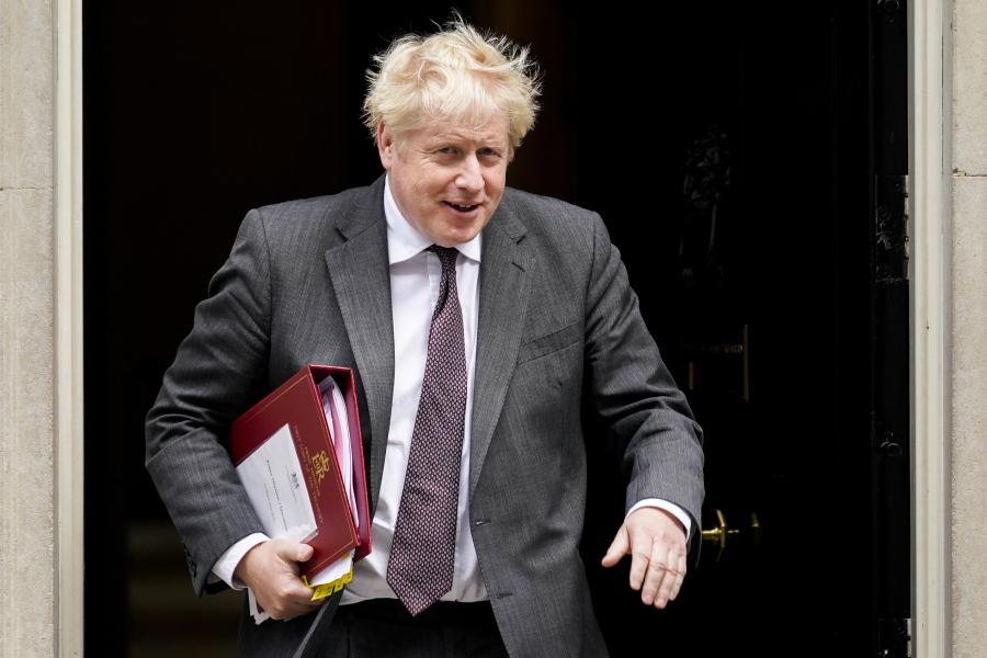 Britain's Prime Minister Boris Johnson leaves 10 Downing Street as he makes his way to Parliament to attend the weekly Prime Minister's Questions session, in London, Wednesday, Sept. 15, 2021.