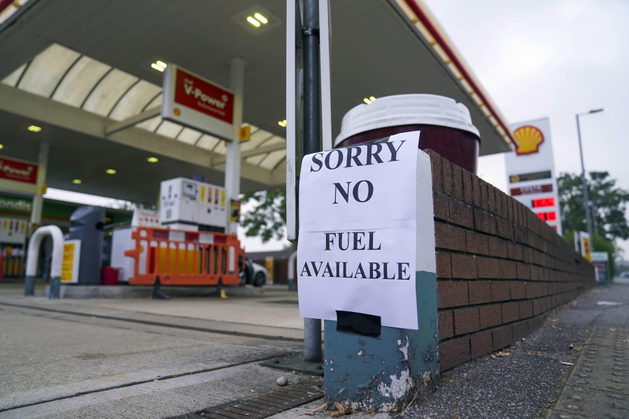 A view of a sign at a petrol station, in Bracknell England, Sunday Sept. 26, 2021. In a U-turn, Britain says it will issue thousands of emergency visas to foreign truck drivers to help fix supply-chain problems that have caused empty supermarket shelves, long lines at gas stations and shuttered petrol pumps.