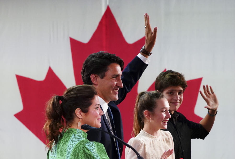 Prime Minister Justin Trudeau is joined on stage by wife Sophie Gregoire Trudeau, left, and children Xavier and Ella-Grace, during his victory speech at Party campaign headquarters in Montreal, early Tuesday, Sept. 21, 2021.