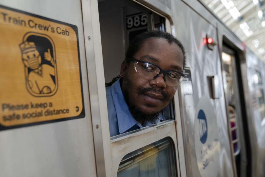 Desmond Hill, a vaccinated MTA conductor, checks the platform for late riders attempting to board the train as he works the N subway line from Brooklyn's Coney Island to Queen's Astoria-Ditmars neighborhoods, Friday, Aug. 13, 2021, in New York. As New York City recovers from the COVID-19 pandemics' peak ridership on the aging transit system continues to rebound as authorities encourage mask and social distancing protocols to stem further transmission of the virus.