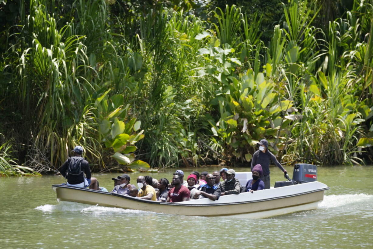 Migrants arrive on a boat to Acandi, Colombia, on Tuesday. The migrants, following a well-beaten, multi-nation journey towards the U.S., will continue their journey through the jungle known as the Darien Gap.