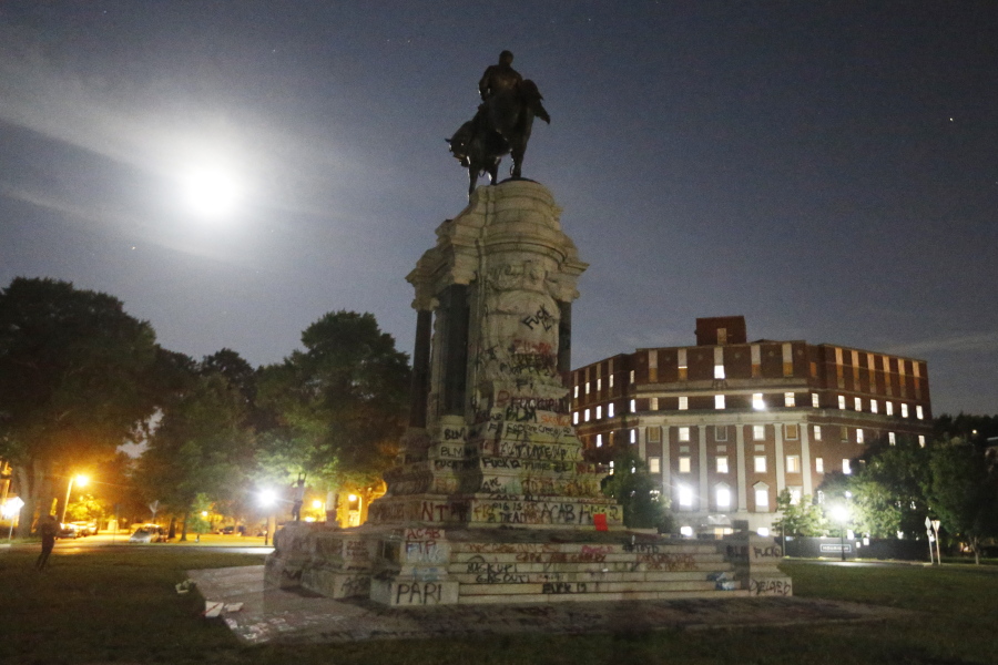 The moon illuminates the statue of Confederate General Robert E. Lee on Monument Avenue Friday June. 5, 2020, in Richmond, Va. The Supreme Court of Virginia ruled Thursday, Sept 2, 2021 that the state can take down an enormous statue that has towered over Monument Avenue in the state's capital for more than a century and has become a symbol of racial injustice.
