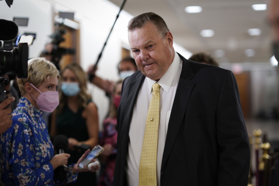 Sen. Jon Tester, D-Mont., stops for reporters asking about the fate of President Joe Biden's $3.5 trillion plan for social and environmental spending, at the Capitol in Washington, Tuesday, Sept. 21, 2021. (AP Photo/J.