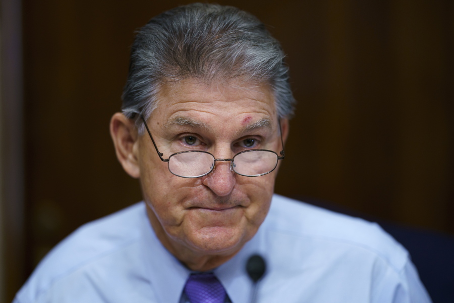 FILE - In this Aug. 5, 2021, file photo Sen. Joe Manchin, D-W.Va., prepares to chair a hearing in the Senate Energy and Natural Resources Committee, as lawmakers work to advance the $1 trillion bipartisan bill, at the Capitol in Washington. Manchin said Thursday, Sept. 2, that Congress should take a "strategic pause" on more spending, warning that he does not support President Joe Biden's plans for a sweeping $3.5 trillion effort to rebuild and reshape the economy. (AP Photo/J.
