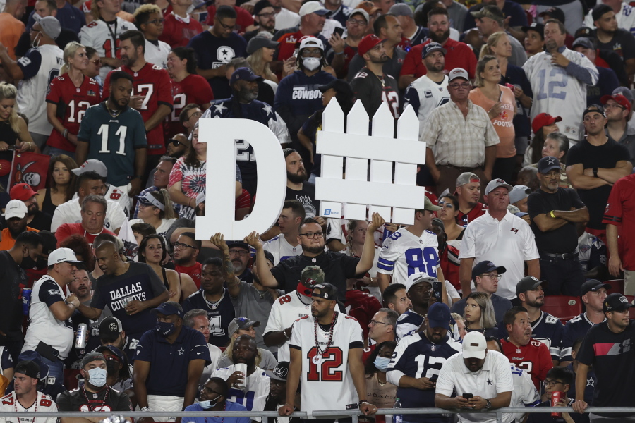 A Tampa Bay Buccaneers fan holds a sign during the first half of an NFL football game against the Dallas Cowboys Thursday, Sept. 9, 2021, in Tampa, Fla.
