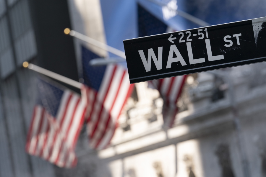 FILE -A sign for Wall Street hangs in front of the New York Stock Exchange, July 8, 2021.  Stocks are off to a mostly lower start on Wall Street Friday, Sept. 17,  as the market heads for a weak ending to an up-and-down week of trading.