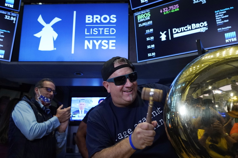 CORRECTS TITLE TO EXECUTIVE CHAIRMAN, NOT PRESIDENT - Dutch Bros Coffee Co-founder and Executive Chairman Travis Boersma rings the ceremonial first trade bell on the floor of the New York Stock Exchange, as his company's IPO opens, Wednesday, Sept. 15, 2021.