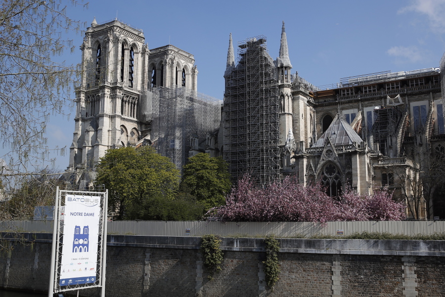 FILE - In this file photo dated Thursday, April 15, 2021, Notre Dame cathedral shrouded in scaffolding in Paris. After more than two-years of work to stabilize and protect it after the shocking fire that tore through its roof and knocked down its spire, France's Notre Dame Cathedral is finally stable and secure enough for artisans to start rebuilding it, according to a government statement Saturday Sept. 18, 2021.