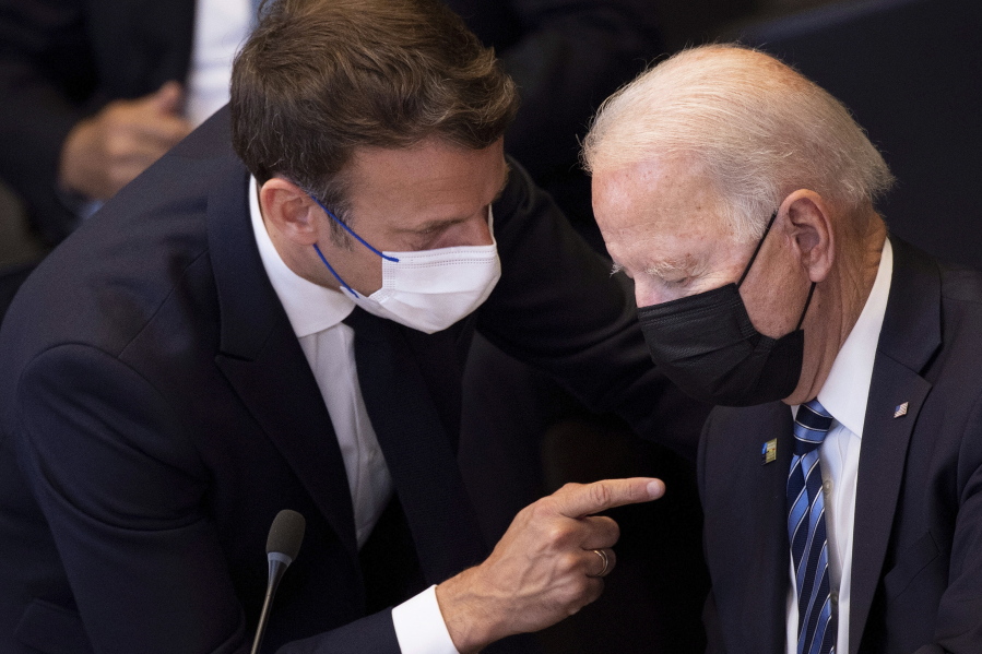 FILE - In this June 14, 2021 file photo, U.S. President Joe Biden, right, speaks with French President Emmanuel Macron during a plenary session during a NATO summit at NATO headquarters in Brussels. French President Emmanuel Macron expects "clarifications and clear commitments" from President Joe Biden in a call to be held later on Wednesday to address the submarines' dispute, Macron's office said.