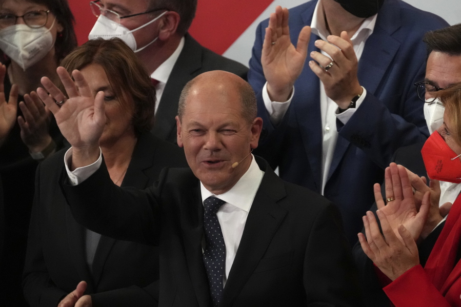 Olaf Scholz, Finance Minister and SPD candidate for Chancellor waves to his supporters after German parliament election at the Social Democratic Party, SPD, headquarters in Berlin, Sunday, Sept. 26, 2021.