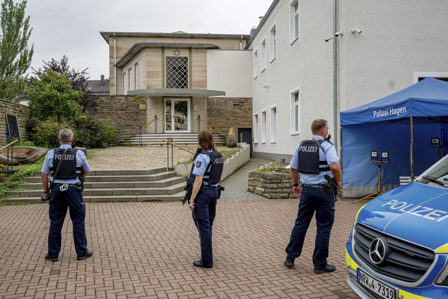 Police officers stay in front of the entrance to the Jewish Community building in Hagen, Germany, Tursday, Sept. 16, 2021. Numerous police officers protected the synagogue in the night, the police spoke of indications of a possible dangerous situation.