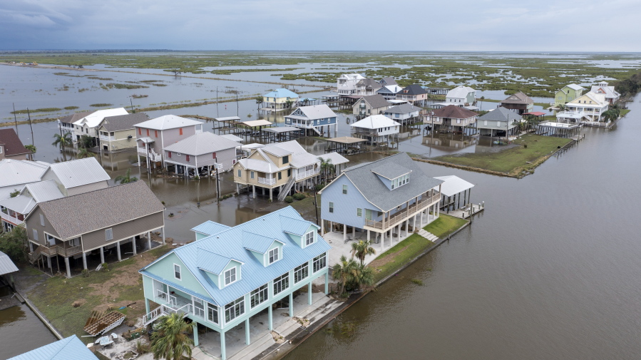 Flood waters still surround homes as residents try to recover from the effects of Hurricane Ida Wednesday, Sept. 1, 2021, in Myrtle Grove, La.