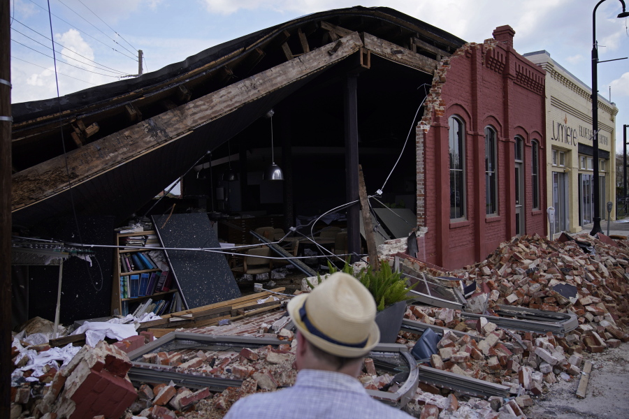 A man looks at a partially collapsed building Saturday in Houma, La.