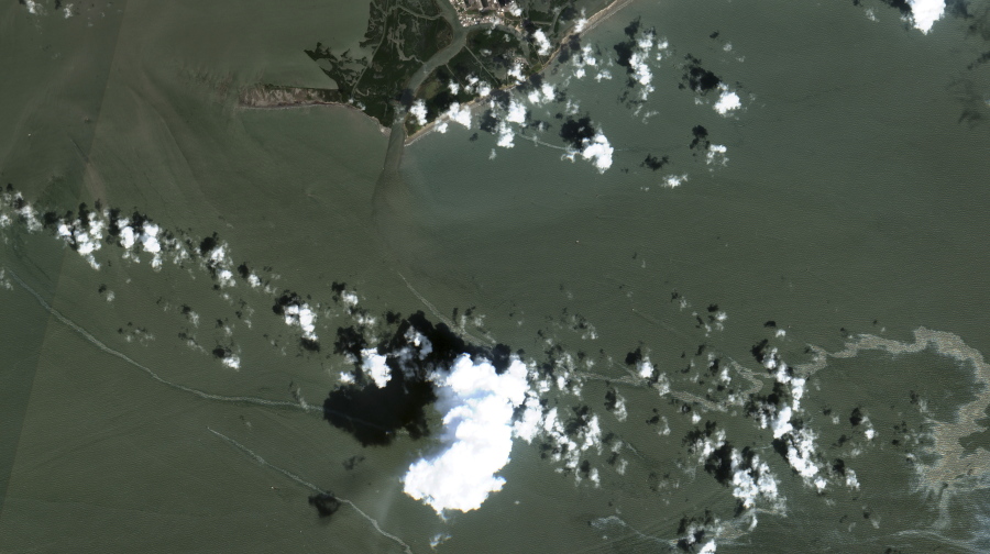 In a satellite image provided by Maxar Technologies, an oil slick is shown on Sept. 2, 2021 south of Port Fourchon, La. as a result of Hurricane Ida. U.S. industrial production slowed in August to a 0.4 percent gain in August as the shutdowns caused by Hurricane Ida took a toll on manufacturing activity. The Federal Reserve reported Wednesday, Sept. 15, 2021 that plant closures forced by Ida for petrochemicals, petroleum refining and other operations along the Gulf Coast had shaved 0.3 percentage point from the output figure. The small August gain was just half the 0.8 percent output increase in July.