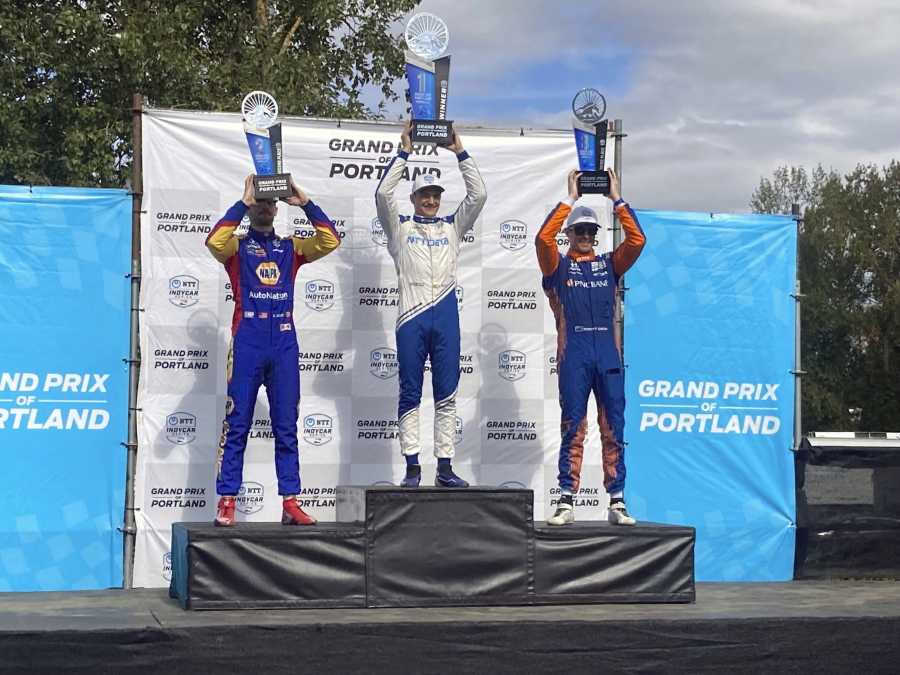 Alex Palou, center, celebrates his third IndyCar win of the season on Sunday, Sept. 12, 2021 at Portland International Raceway in Portland, Ore. Palou's win moved him back atop the IndyCar championship standings with two races remaining. Alexander Rossi finished second and Scott Dixon, teammates with Palou at Chip Ganassi Racing, finished third.