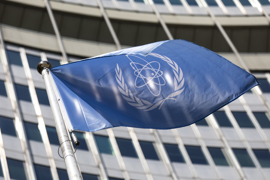 FILE - In this Monday, June 7, 2021 file photo, the flag of the International Atomic Energy Agency (IAEA) waves at the entrance of the Vienna International Center in Vienna.