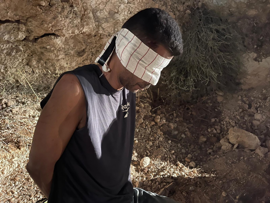 In this photo provided by Israel Police, Zakaria Zubeidi, one of the six Palestinians who escaped from a high-security prison earlier this week, is blindfolded after being recaptured in the Arab town of Umm al-Ghanam, northern Israel, Saturday, Sept. 11, 2021. Israeli police on Saturday said they have arrested four of the six Palestinians who broke out of a maximum-security prison this week including Zubeidi, a famed militant leader whose exploits over the years have made him a well-known figure in Israel.