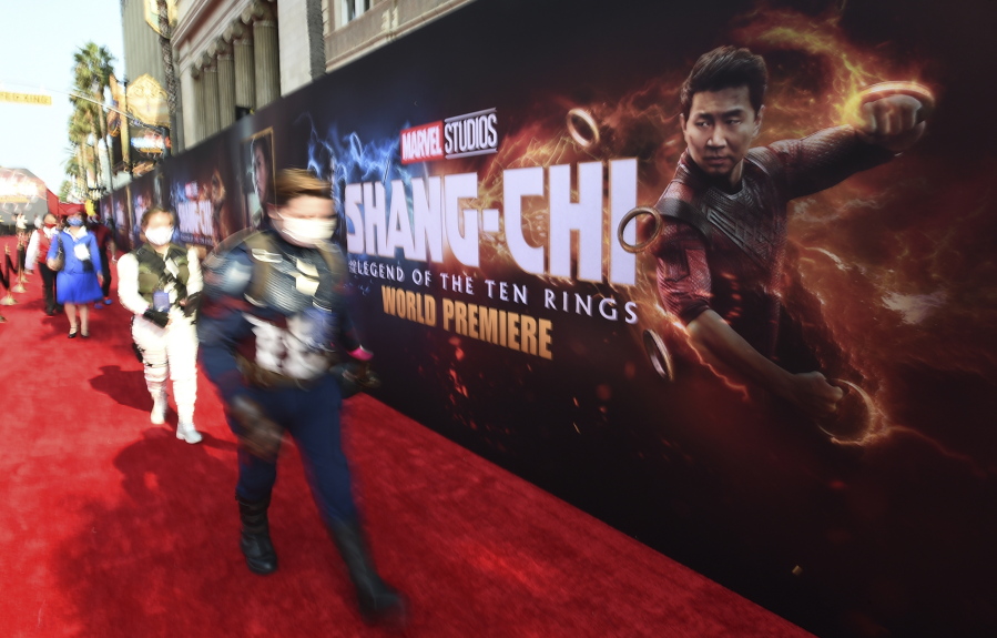 Fans dressed as Marvel characters attend the premiere of "Shang-Chi and the Legend of the Ten Rings" on Monday, Aug. 16, 2021, at the El Capitan Theatre in Los Angeles.