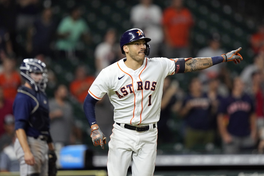 Houston Astros' Carlos Correa (1) celebrates after hitting a game-winning RBI ground-rule double against the Seattle Mariners during the 10th inning of a baseball game Tuesday, Sept. 7, 2021, in Houston. The Astros won 5-4 in 10 innings. (AP Photo/David J.