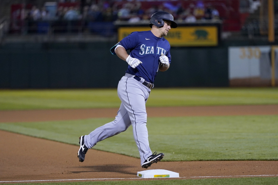 Seattle Mariners' Kyle Seager rounds the bases after hitting a home run against the Oakland Athletics during the fourth inning of a baseball game in Oakland, Calif., Wednesday, Sept. 22, 2021.