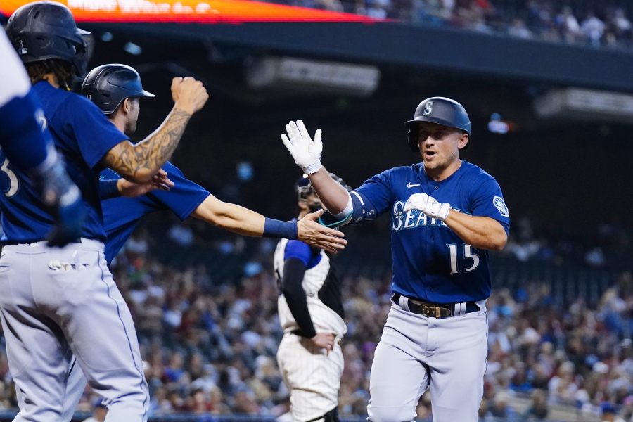 Seattle Mariners' Kyle Seager (15) celebrates his three-run home run against the Arizona Diamondbacks with Mariners' J.P. Crawford, left, and Mitch Haniger during the first inning of a baseball game Saturday, Sept. 4, 2021, in Phoenix. (AP Photo/Ross D.